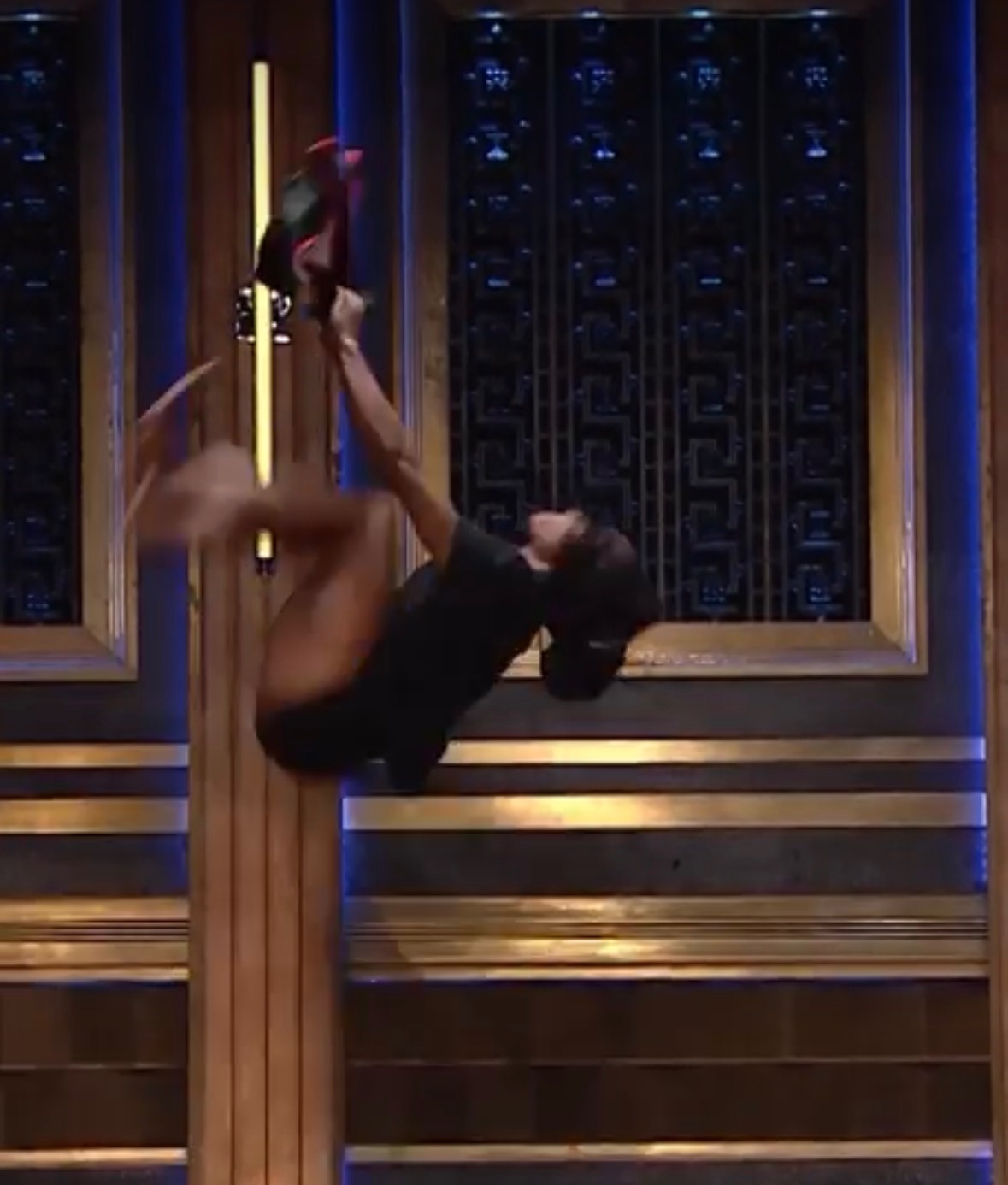 Ajiea Lee Hargrave performing an athletic movement on a television set