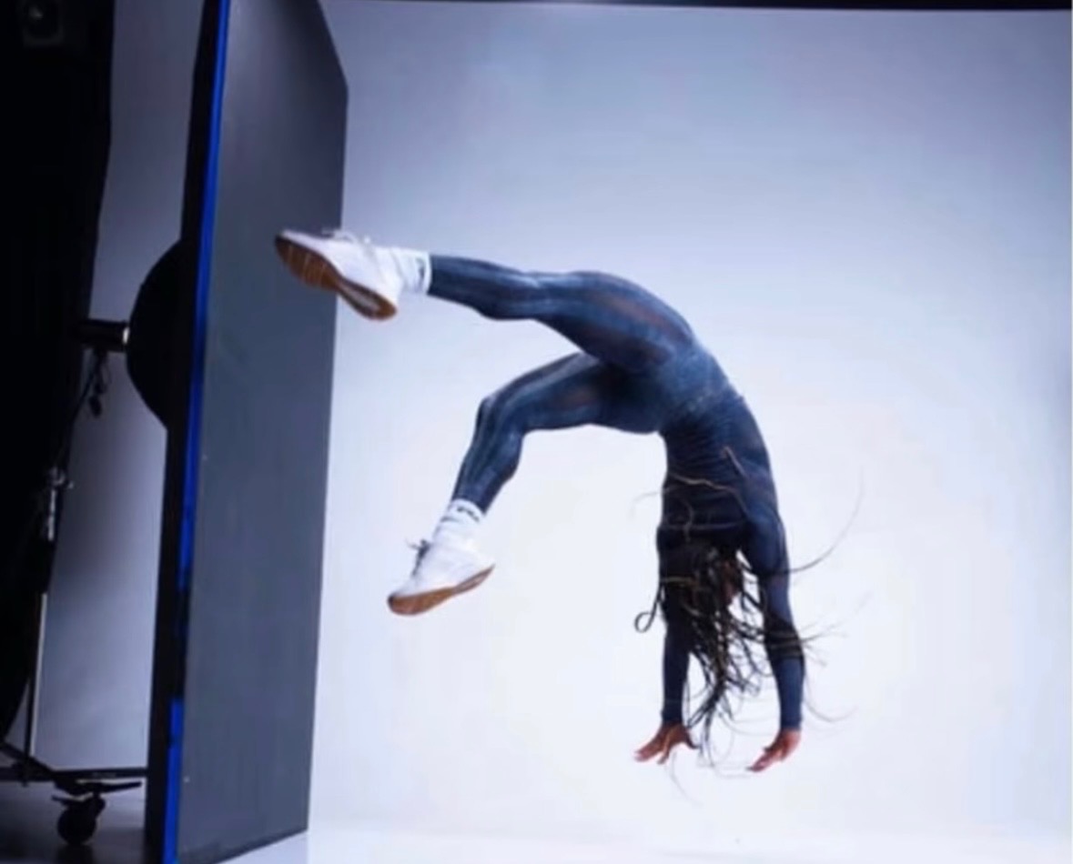Ajiea performing a backflip in a studio